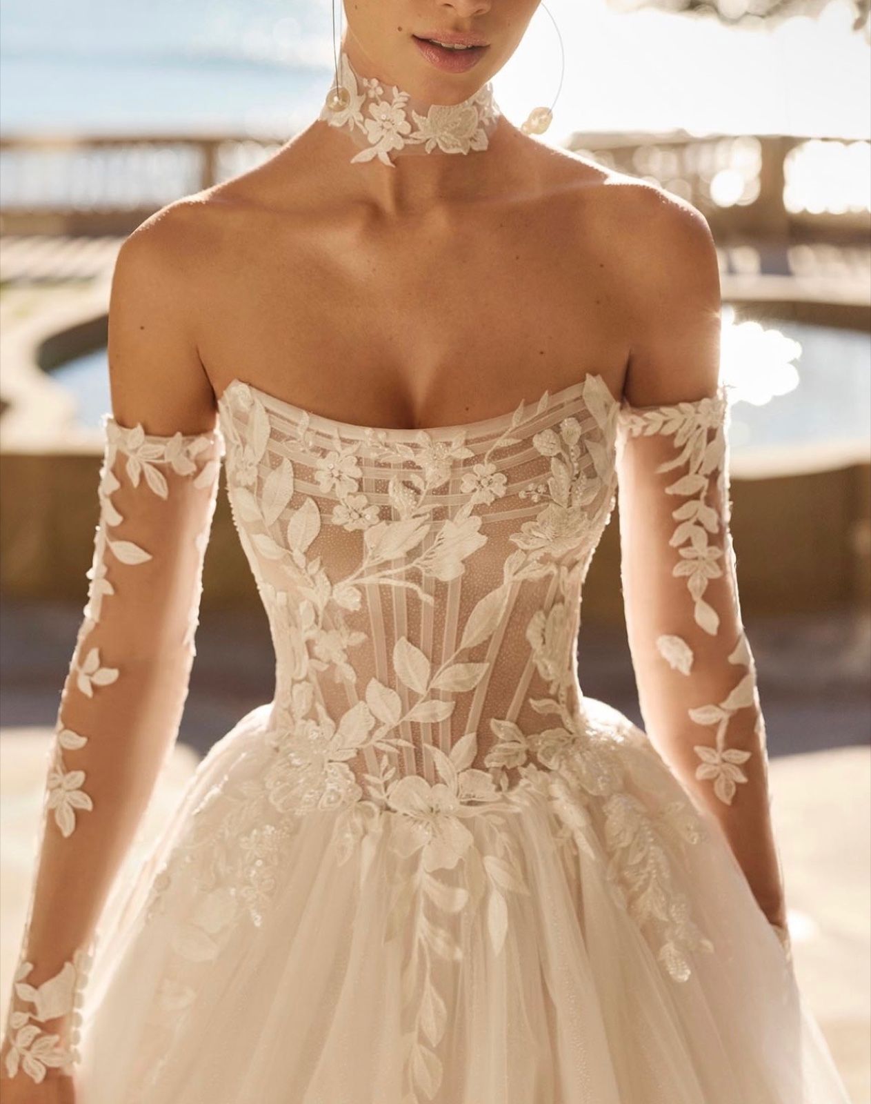 Close-up of a sheer lace bodice with floral lace sleeves